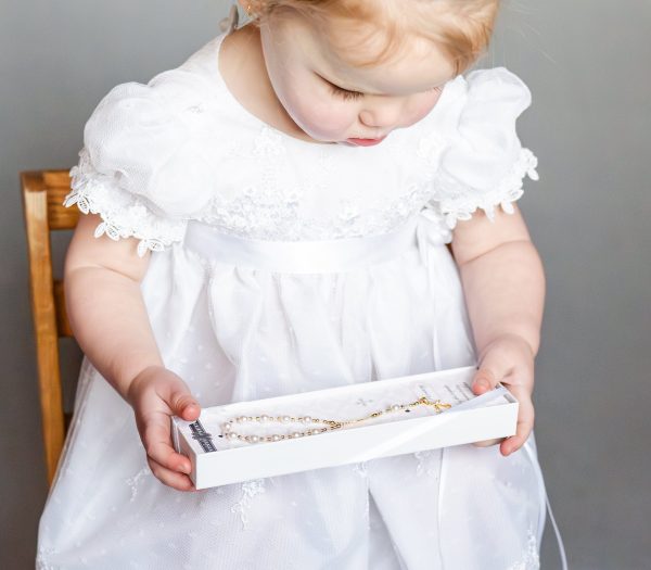 Baby wearing 14K Gold-Plated White Baby Rosary Baptism Gift